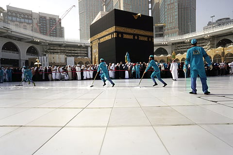 Workers sterilize the ground in front of the Kaaba, the cubic building at the Grand Mosque, in the Muslim holy city of Mecca, Saudi Arabia. (Photo | AP)