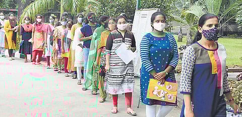 Adhering to Covid-19 safety norms, candidates enter Padmavathi Degree College in Tirupati on Sunday to appear for Civil Services preliminary exam | Madhav K