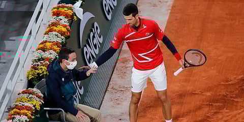 Serbia's Novak Djokovic checks on a linesman after a ball spun off his racket in a French Open match against Russia's Karen Khachanov. (Photo| AP)