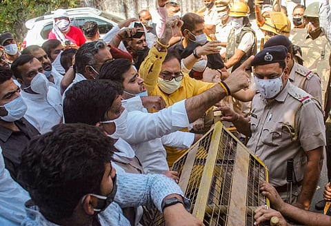 Police personnel try to stop Congress workers while they were on their way to Mahatma Gandhi statue during a protest over the death of a 19-year-old Dalit woman . (Photo | PTI)