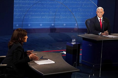 Vice President Mike Pence looks at Democratic vice presidential candidate Sen. Kamala Harris, D-Calif., as she answers a question during the vice presidential debate. (Photo | AP)