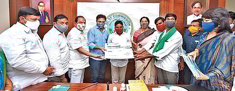 Industries Minister KT Rama Rao hands over cheques to SC/ST entrepreneurs in Hyderabad on Wednesday