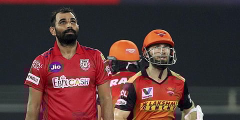Kings XI Punjab's Mohammad Shami and Sunrisers Hyderabad batsman Kane Williamson watch the ball as it reaches the boundary for a six during an IPL 2020 match. (Photo| PTI)