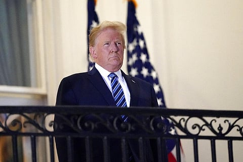 President Donald Trump stands on the balcony outside of the Blue Room as returns to the White House Monday, Oct. 5, 2020, in Washington. (Photo | AP)