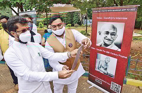 Tourism Kannada & Culture Minister CT Ravi scans the code for an interactive experience on the life of Mahatma Gandhi in Bengaluru on Friday | Vinod Kumar T