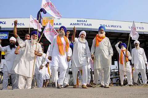 Members of various farmers organizations block toll gates on the National Highway (NH1) during a protest over the new farm reform bills, in Amritsar, Friday, Oct. 9, 2020. (Photo | PTI)
