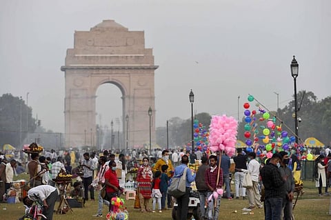 People at Rajpath lawns in the backdrop of India Gate amid the coronavirus pandemic in New Delhi Sunday Nov. 1 2020. (Photo | PTI)