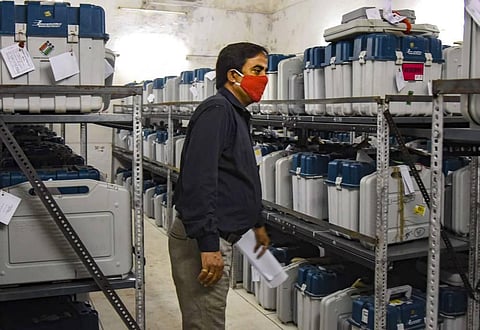 An election official checks Electronic Voting Machines in a strong room during counting day of Bihar Assembly polls in Patna. (Photo | PTI)