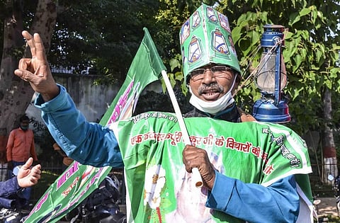 RJD supporters flash victory sign during counting of votes for the Bihar Assembly polls in Patna Tuesday Nov. 10 2020. (Photo | PTI)