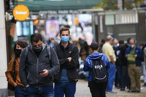 People line up outside a Covid-19 testing site in New York. (Photo | AFP)
