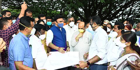 Medical education and health minister Dr K Sudhakar interacting with the engineers during the inspection of the land allocated for setting up of the government medical college at Chitradurga on Friday