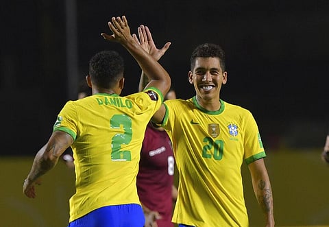 Brazil's Roberto Firmino, right, celebrates with teammate Brazil's Danilo after scoring his side's opening goal against Venezuela. (Photo | AP)