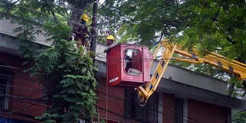 KSEB officials using a crane to lift workers to do repair works in the electric line here at Poojappura, Thiruvananthapuram. (Photo| Vincent Pulickal, EPS)
