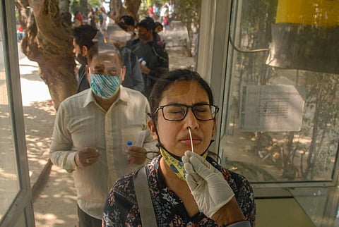 A health worker conducts COVID-19 testing in Noida. (Photo | PTI)
