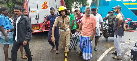 TNFRS men and locals removing a body from the site. (Photo | EPS)