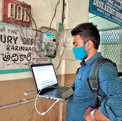 An employee of the TSNPDCL’s technical wing clears technical error in one of the prepaid electricity meters installed at the Karimnagar district audit office