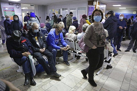 People, wearing face masks to help curb the spread of the coronavirus wait for a doctor's appointment at an outpatient care in Siberian city of Omsk, Russia. (Photo | AP)