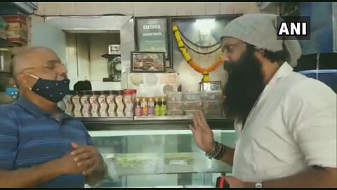 Shiv Sena leader Nitin Nandgaon talking to the owner of the 'Karachi Sweets' shop in Mumbai (Photo | EPS)