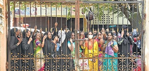 Women peer through the closed gates of a Mee Seva Centre after it stopped taking registrations for flood relief as per SEC directions in Hyderabad on Wednesday |RVK Rao