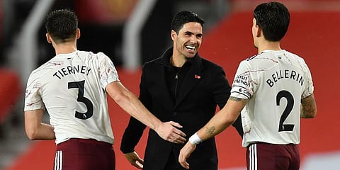 Arsenal manager Mikel Arteta (C) celebrates with Hector Bellerin (R) and Kieran Tierney during the EPL match against Manchester United at the Old Trafford stadium. (Photo | AP)