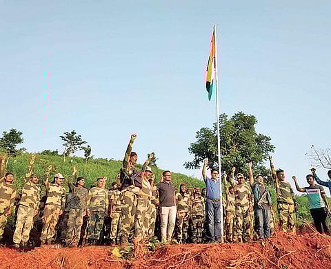 SP Rishikesh Khilari and BSF officials after unfurling the national flag at Gorasetu village in Swabhiman Anchal on Saturday. (Photo | EPS)
