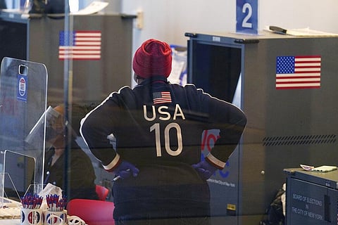 A poll worker wearing patriotic clothing pauses between supervising other workers on the last day of early voting in New York (Photo | AP)