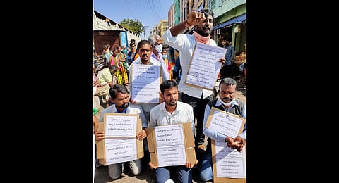 People who contested 2018 Assembly elections as independent candidates protest in front of the Vemulawada temple in Rajanna-Sircilla district on Thursday, ‘begging’ money to bring back Vemulawada MLA.