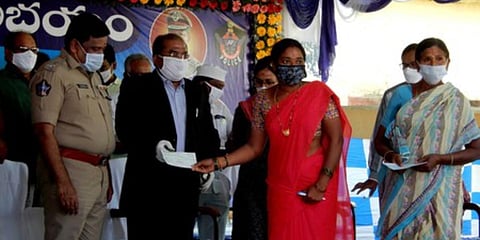 Krishna collector A Md Imtiaz and SP M Ravindranath Babu distribute compensation to farmers at Chatrai village. (Photo| EPS)