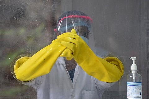 Tutorials are circulating online on the proper way to eat and drink at restaurants while wearing masks. (Photo| AFP)