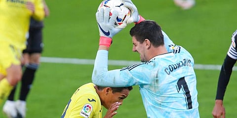 Real Madrid's goalkeeper Thibaut Courtois collects the ball ahead of Villareal's Carlos Bacca. (Photo | AP)