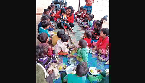 Janki Chand with children at an anganwadi centre in Banbasa. She also teaches underprivileged kids | Express
