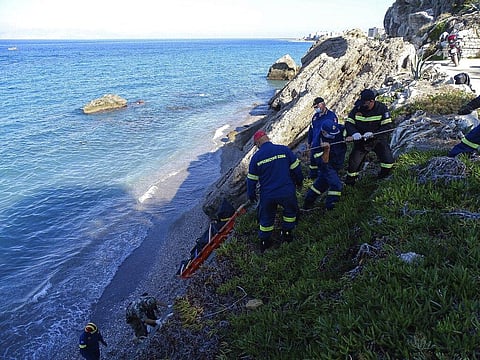 Firefighters retrieve the body of a migrant from the beach after a shipwreck on the island of Rhodes. (Photo | AP)
