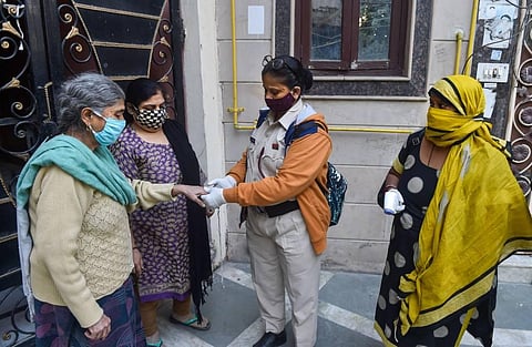 Volunteers use an oximeter to measure the oxygen level during a door-to-door campaign to check symptomatic COVID-19 residents. (Photo | PTI)