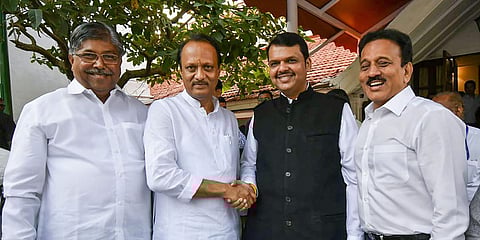 Former Maharashtra CM Devendra Fadnavis (R) shakes hands with NCP leader Ajit Pawar. (File photo| PTI)