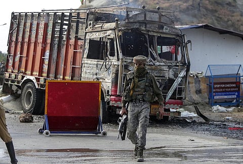 An Indian army soldier walks near the site of a gunfight between suspected rebels and Indian security forces at a checkpoint in Nagrota, outskirts of Jammu. (Photo | AP)