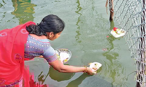 A woman offering prayers to the Tungabhadra at a Kurnool pushkar ghat I Express