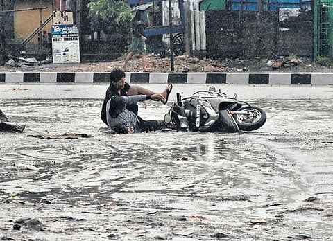 With the city receiving heavy rainfall on Wednesday, it was tricky to ride on the roads. A couple of motorists fell down on Manali High Road in Tiruvottiyur | P Jawahar