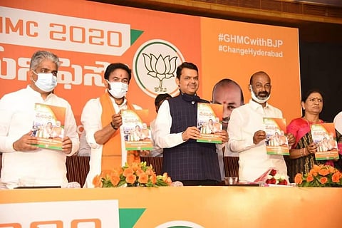 Former Maharashtra CM Devendra Fadnavi releasing party manifesto for GHMC polls on Thursday (Photo | Twitter/ #GHMCElections2020)