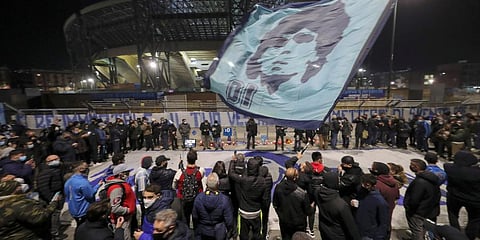 People gather outside the San Paolo Stadium to pay their homage to soccer legend Diego Maradona, in Naples, Italy. (Photo | AP)