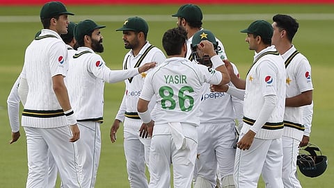 Pakistan's Yasir Shah (C) celebrates with team mates after taking the wicket. (Photo | AFP)