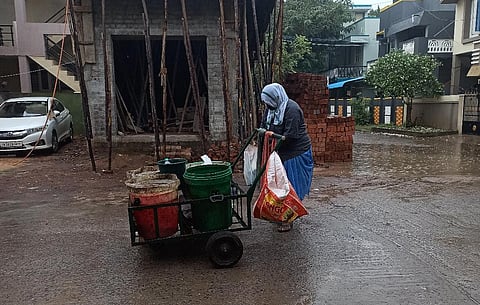 A sanitary worker sans raincoat. (Photo| EPS)