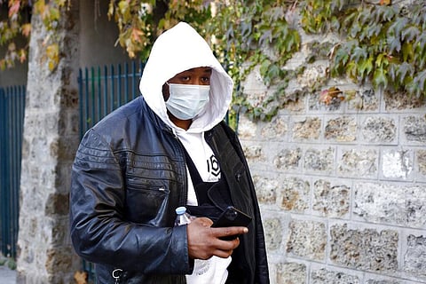 Music producer identified only by his first name, Michel, is pictured on his way to the Inspectorate General of the National Police, known by its French acronym IGPN, in Paris, Thursday. (Photo | AP)