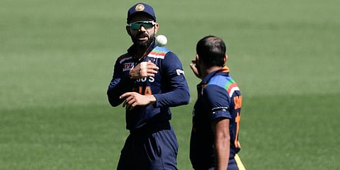 India's Virat Kohli (L) throws the ball to Mohammed Shami during the ODI match against Australia at the Sydney Cricket Ground. (Photo | AP)