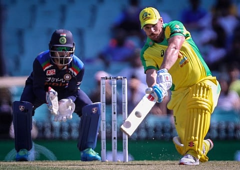 Australia's captain Aaron Finch hits a six as India's wicketkeeper KL Rahul watches. (Photo | AFP)