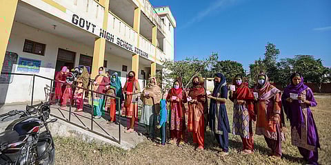 West Pakistani refugees stand in a queue as they wait to cast their votes for the District Development Council elections, at a polling station in Akhnoor of Jammu district, Saturday. (Photo | PTI)