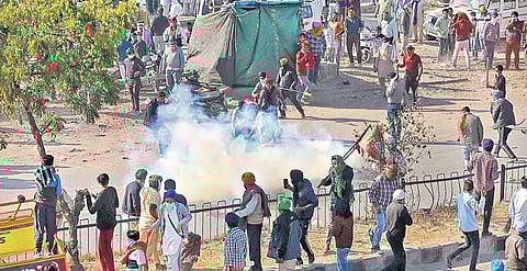 Police use teargas on farmers to stop them from crossing Singhu border during ‘Delhi Chalo’ march on Friday