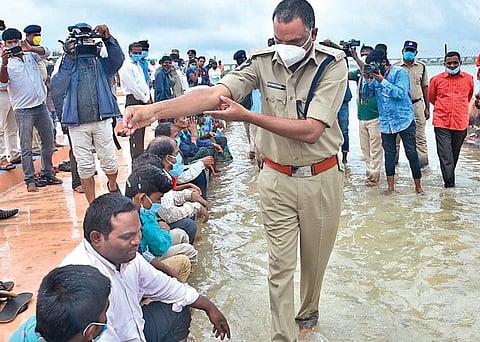 SP K Fakeerappa sprinkling holy water of River Tungabhadra on the differently abled at a pushkar ghat in Kurnool on Friday I Express