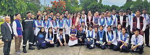 East Siang DM Kinny Singh (centre) with students and teachers of a government school; (below) a renovated school. (Photo | EPS)