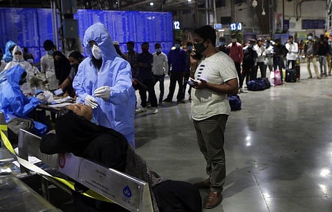 A health worker takes a nasal swab sample of a passenger to test for COVID-19 at Chhatrapati Shivaji Maharaj Terminus railway station in Mumbai, India, Saturday, Nov. 28, 2020. (Photo | AP)