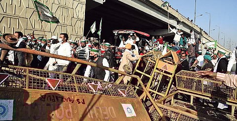 BKU members cross a police barricade at Ghazipur on Saturday. (Photo | Shekhar Yadav & Parveen Negi/EPS)